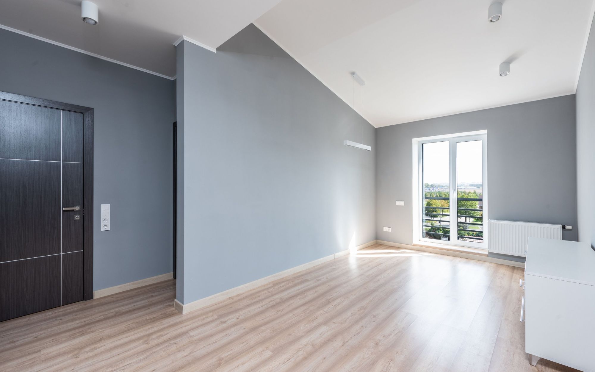 The same room after painting: fresh gray walls and clean trim